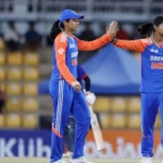 An image of Smriti Mandhana and Radha Yadav celebrating a breakthrough