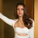 Triptii Dimri posing for the camera in a white dress